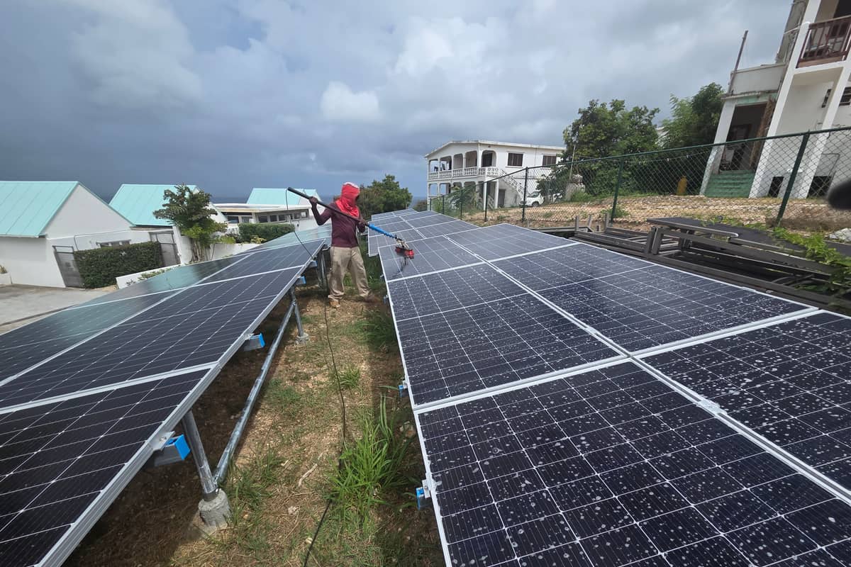 Rows of ground-mounted solar panels on galvanised frames