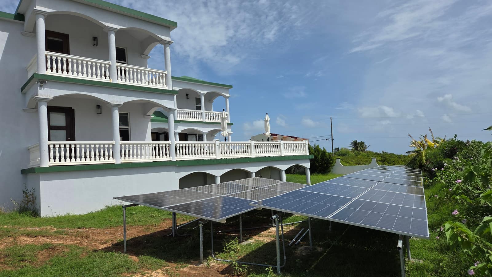 Ground-mounted solar array in the garden of a Caribbean villa